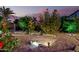 Charming backyard featuring rock landscaping, sunflowers, and ambient lighting for evening enjoyment at 31453 N Blackfoot Dr, San Tan Valley, AZ 85143