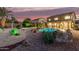 Scenic backyard with a sparkling pool, desert landscaping, and lush greenery, ideal for relaxation and entertainment at 31453 N Blackfoot Dr, San Tan Valley, AZ 85143
