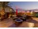 Inviting outdoor patio with a cozy fire pit, comfortable seating, and a built-in grill, perfect for entertaining at 31453 N Blackfoot Dr, San Tan Valley, AZ 85143