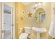 Charming powder room with pedestal sink, floral accents and half bathroom at 31453 N Blackfoot Dr, San Tan Valley, AZ 85143