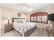Bedroom featuring carpet flooring, ceiling fan, bedside tables with lamps, and large shuttered window at 31453 N Blackfoot Dr, San Tan Valley, AZ 85143