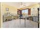 Bonus room features carpet flooring, ceiling fan, and shelving units for storage or display at 31453 N Blackfoot Dr, San Tan Valley, AZ 85143