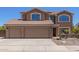Charming two-story home featuring a spacious three-car garage and well-manicured desert landscape at 31453 N Blackfoot Dr, San Tan Valley, AZ 85143