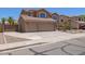 Inviting two-story home featuring a spacious three-car garage and well-maintained desert landscape at 31453 N Blackfoot Dr, San Tan Valley, AZ 85143