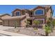 Charming two-story home featuring a spacious three-car garage and well-manicured desert landscape at 31453 N Blackfoot Dr, San Tan Valley, AZ 85143