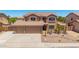Expansive two-story home featuring a large three-car garage and well-maintained desert landscape at 31453 N Blackfoot Dr, San Tan Valley, AZ 85143