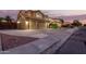 Beautiful two-story home with a spacious driveway and well-lit exterior, captured at dusk at 31453 N Blackfoot Dr, San Tan Valley, AZ 85143