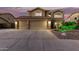 Inviting two-story home featuring a spacious three-car garage with stone accents and manicured front yard at 31453 N Blackfoot Dr, San Tan Valley, AZ 85143
