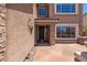 Close up of a front entrance with a rustic textured front with decorative art at 31453 N Blackfoot Dr, San Tan Valley, AZ 85143