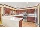 Modern kitchen with stainless steel appliances, white countertops, and dark wood cabinetry at 31453 N Blackfoot Dr, San Tan Valley, AZ 85143