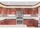 A kitchen with a stainless steel range and microwave with a backsplash at 31453 N Blackfoot Dr, San Tan Valley, AZ 85143
