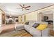 Spacious living area, ceiling fan, and views into the kitchen area at 31453 N Blackfoot Dr, San Tan Valley, AZ 85143