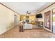 Cozy living room with fireplace, ceiling fan, and access to the outdoor patio at 31453 N Blackfoot Dr, San Tan Valley, AZ 85143