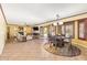 Open concept living room and dining area with updated lighting, tile flooring, and fireplace at 31453 N Blackfoot Dr, San Tan Valley, AZ 85143