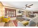 Comfortable living room offering ceiling fan, tile floors, and views into the kitchen at 31453 N Blackfoot Dr, San Tan Valley, AZ 85143