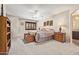 Serene main bedroom boasts neutral tones, ceiling fan and a view to the main bathroom at 31453 N Blackfoot Dr, San Tan Valley, AZ 85143
