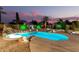 Inviting pool area features a rock waterfall, desert landscaping, and custom ambient lighting at 31453 N Blackfoot Dr, San Tan Valley, AZ 85143