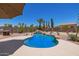 Sparkling pool features a waterfall feature, desert landscaping, and plenty of room to relax at 31453 N Blackfoot Dr, San Tan Valley, AZ 85143
