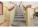 Carpeted staircase with wood railing and handrail, leading to the upper level of the home at 31453 N Blackfoot Dr, San Tan Valley, AZ 85143
