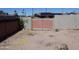 Wide shot of a spacious backyard with gravel and a block wall, providing ample room for outdoor activities at 3171 W Orchid Ln, Phoenix, AZ 85051