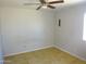 This bedroom features tile floors, a ceiling fan, and a window for natural light at 3171 W Orchid Ln, Phoenix, AZ 85051