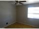 This bedroom features tile floors, a ceiling fan, and a window for natural light at 3171 W Orchid Ln, Phoenix, AZ 85051