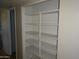 This walk-in closet contains plenty of shelves for organization at 3171 W Orchid Ln, Phoenix, AZ 85051