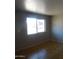 Bright living room featuring tile floors and a large window for ample natural light at 3171 W Orchid Ln, Phoenix, AZ 85051