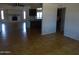 Open-concept living area showcasing tile floors, fireplace and connection to kitchen at 3171 W Orchid Ln, Phoenix, AZ 85051