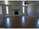 Spacious living room with a brick fireplace and large windows for natural light at 3171 W Orchid Ln, Phoenix, AZ 85051