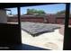 View from the house of the backyard pool covered for protection and privacy at 3171 W Orchid Ln, Phoenix, AZ 85051