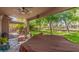 Covered patio overlooking a well-manicured lawn and mature trees at 3274 E Denim Trl, San Tan Valley, AZ 85143