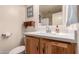 Bathroom featuring white countertop, decorative mirror, and wood vanity with updated fixtures at 3274 E Denim Trl, San Tan Valley, AZ 85143