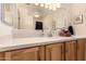 Well lit bathroom featuring a quartz countertop and a large mirror at 3274 E Denim Trl, San Tan Valley, AZ 85143
