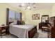 Cozy bedroom with plush carpet, natural light, and a view of the neighborhood at 3274 E Denim Trl, San Tan Valley, AZ 85143