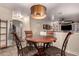 Cozy breakfast nook with round wood table and seating for four adjacent to the living room at 3274 E Denim Trl, San Tan Valley, AZ 85143