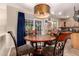 This cozy breakfast nook has a stylish copper light fixture and sliding glass doors to the patio at 3274 E Denim Trl, San Tan Valley, AZ 85143