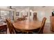 Elegant dining room with a wood table and seating for six, adjacent to the living area for easy access at 3274 E Denim Trl, San Tan Valley, AZ 85143