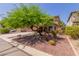 Attractive two-story home with well-maintained desert landscaping and a shade tree in the front yard at 3274 E Denim Trl, San Tan Valley, AZ 85143