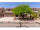 Charming two-story home featuring desert landscaping and a large shade tree in the front yard at 3274 E Denim Trl, San Tan Valley, AZ 85143