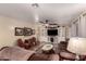 Spacious living room with wooden floors, TV, ceiling fan and an oversized brown sofa at 3274 E Denim Trl, San Tan Valley, AZ 85143