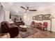 Spacious living room with hardwood floors, a ceiling fan, and an open layout leading to the kitchen at 3274 E Denim Trl, San Tan Valley, AZ 85143