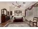 Comfortable main bedroom featuring a ceiling fan, area rug and natural light at 3274 E Denim Trl, San Tan Valley, AZ 85143