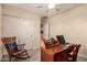 Bright home office with storage, natural light and a comfortable chair at 3274 E Denim Trl, San Tan Valley, AZ 85143