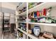 Organized walk-in pantry with ample shelving for food storage and a beverage cooler at 3274 E Denim Trl, San Tan Valley, AZ 85143