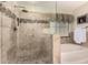Beautiful tiled shower with glass door, tub, and neutral color palette at 3274 E Denim Trl, San Tan Valley, AZ 85143