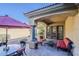 Covered outdoor patio featuring a dining table, chairs, couch, and an umbrella at 3406 E Pyrenees Pass, Phoenix, AZ 85018