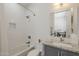 Neutral toned bathroom features a bath tub, shower, and vanity with granite countertops and a gray cabinet at 3406 E Pyrenees Pass, Phoenix, AZ 85018