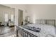 Bright bedroom featuring wood floors, a mirror closet, and an ensuite bathroom at 3406 E Pyrenees Pass, Phoenix, AZ 85018