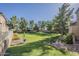 Large, well-maintained community green space with manicured lawn and mature trees provides a relaxing and inviting atmosphere at 3406 E Pyrenees Pass, Phoenix, AZ 85018